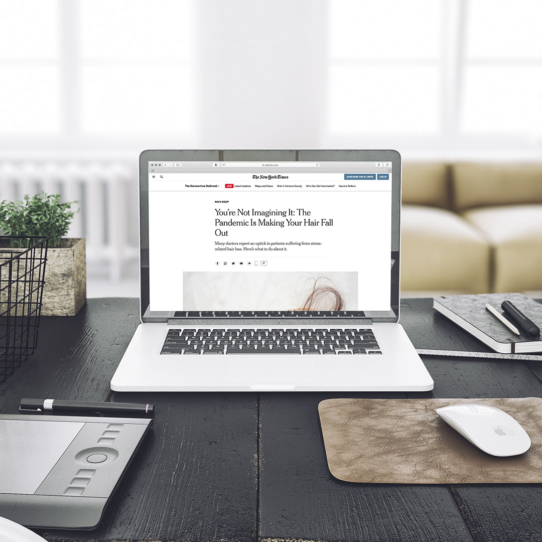Image of a laptop opened up to a NY Times article titled "You're Not Imaging It: The Pandemic is Making Your Hair Fall Out"
